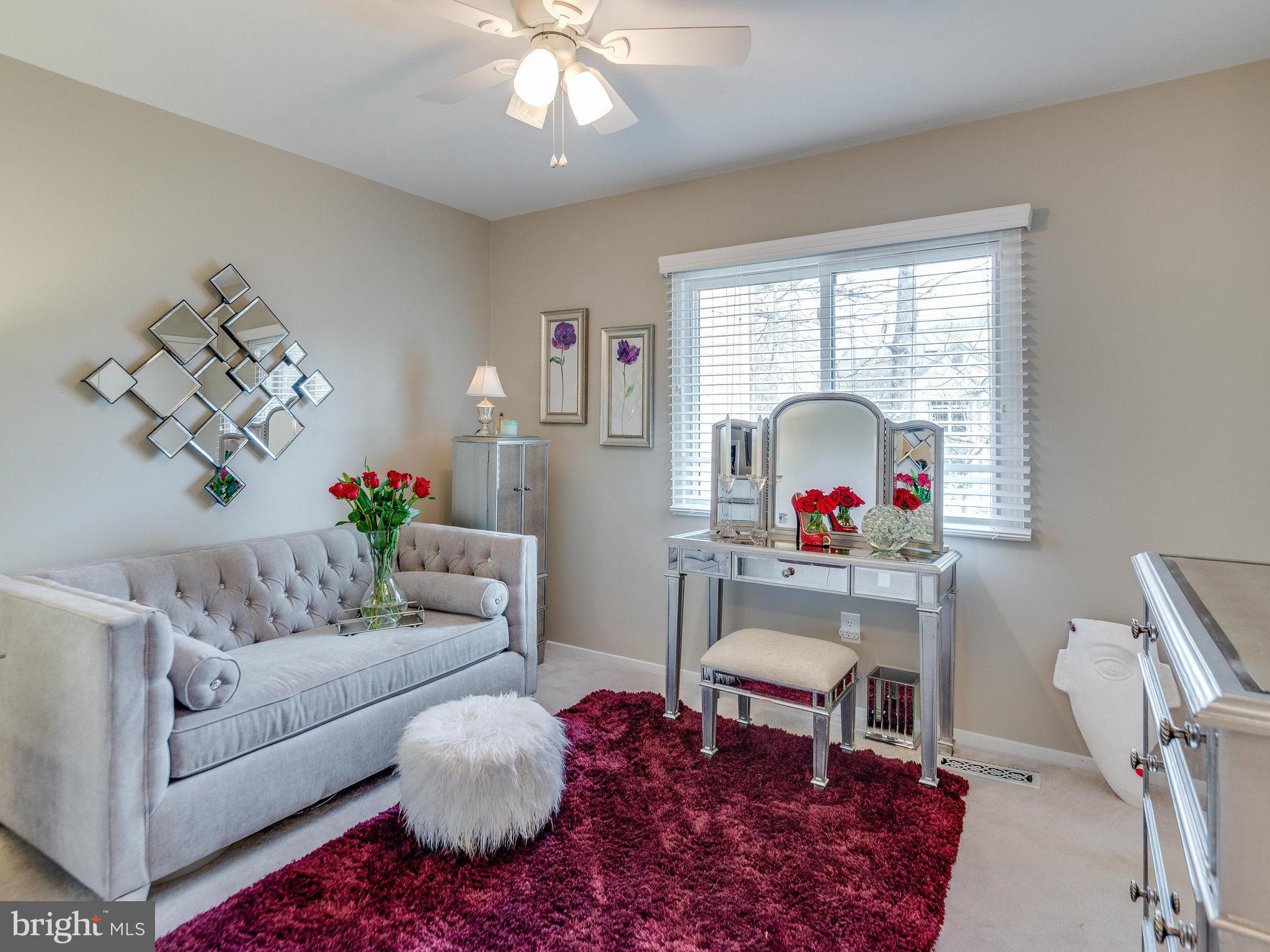 2269 Wheelwright Court Reston, VA 20191 - Photo 17 of 28 a living room with furniture a rug and a chandelier