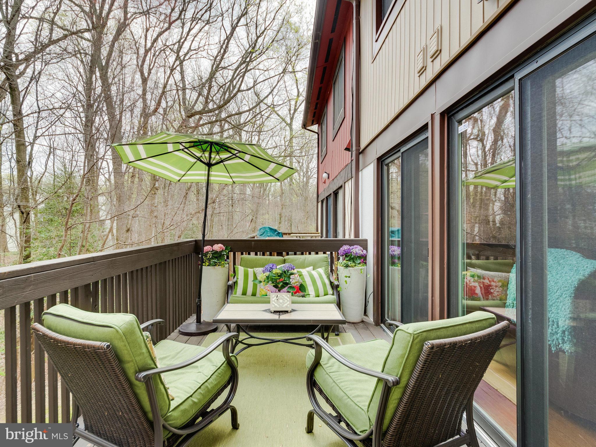 2269 Wheelwright Court Reston, VA 20191 - Photo 24 of 28 a view of a patio with couches chairs under an umbrella