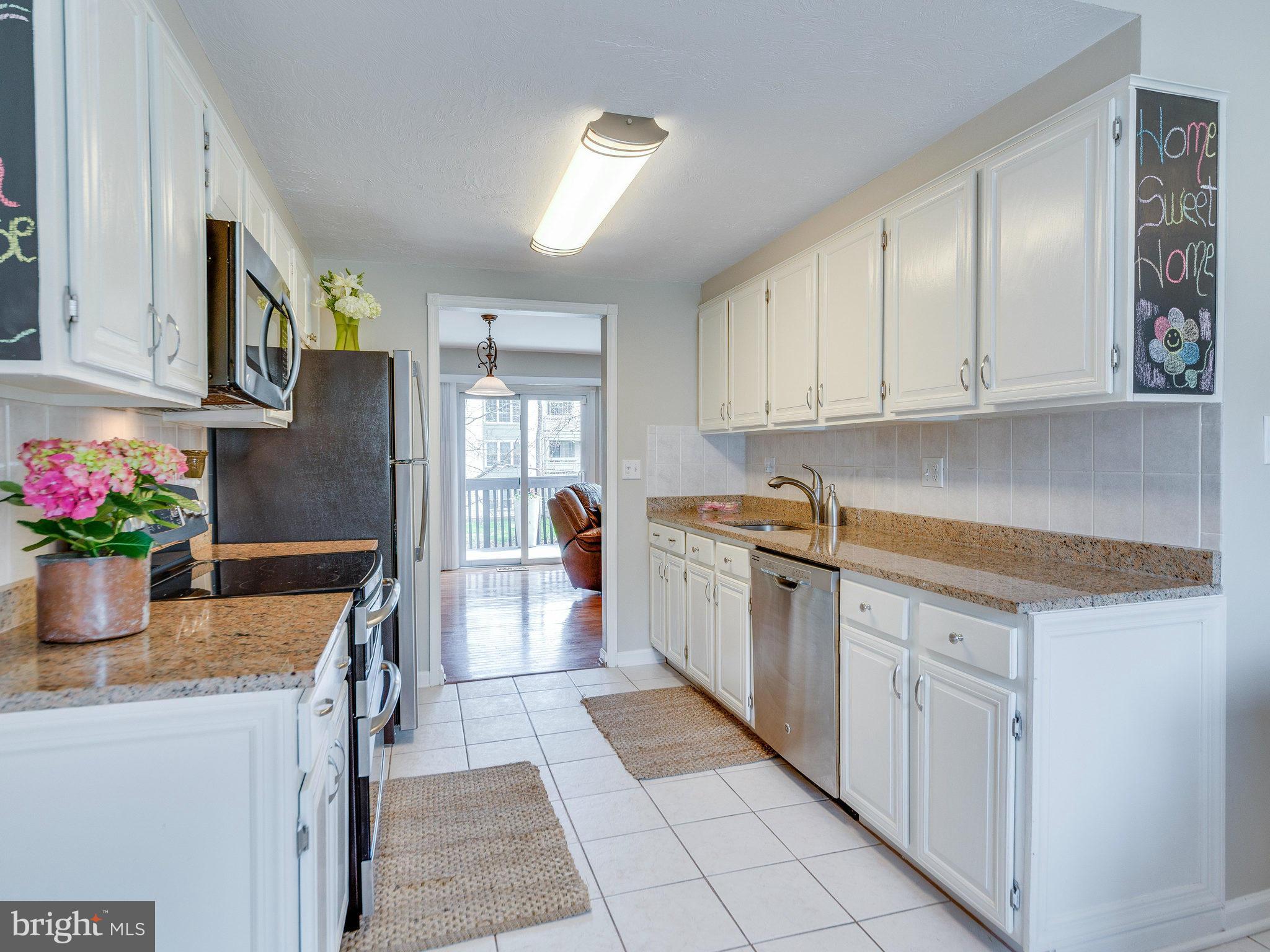 2269 Wheelwright Court Reston, VA 20191 - Photo 6 of 28 a kitchen with stainless steel appliances granite countertop a refrigerator sink and cabinets