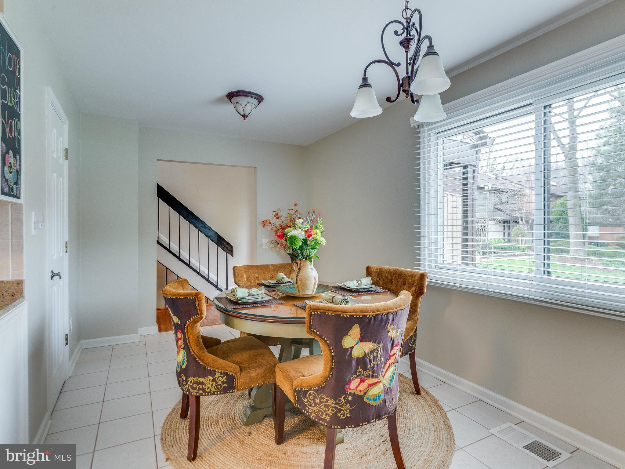 2269 Wheelwright Court Reston, VA 20191 - Photo 8 of 28 a dining room with furniture potted plants and wooden floor