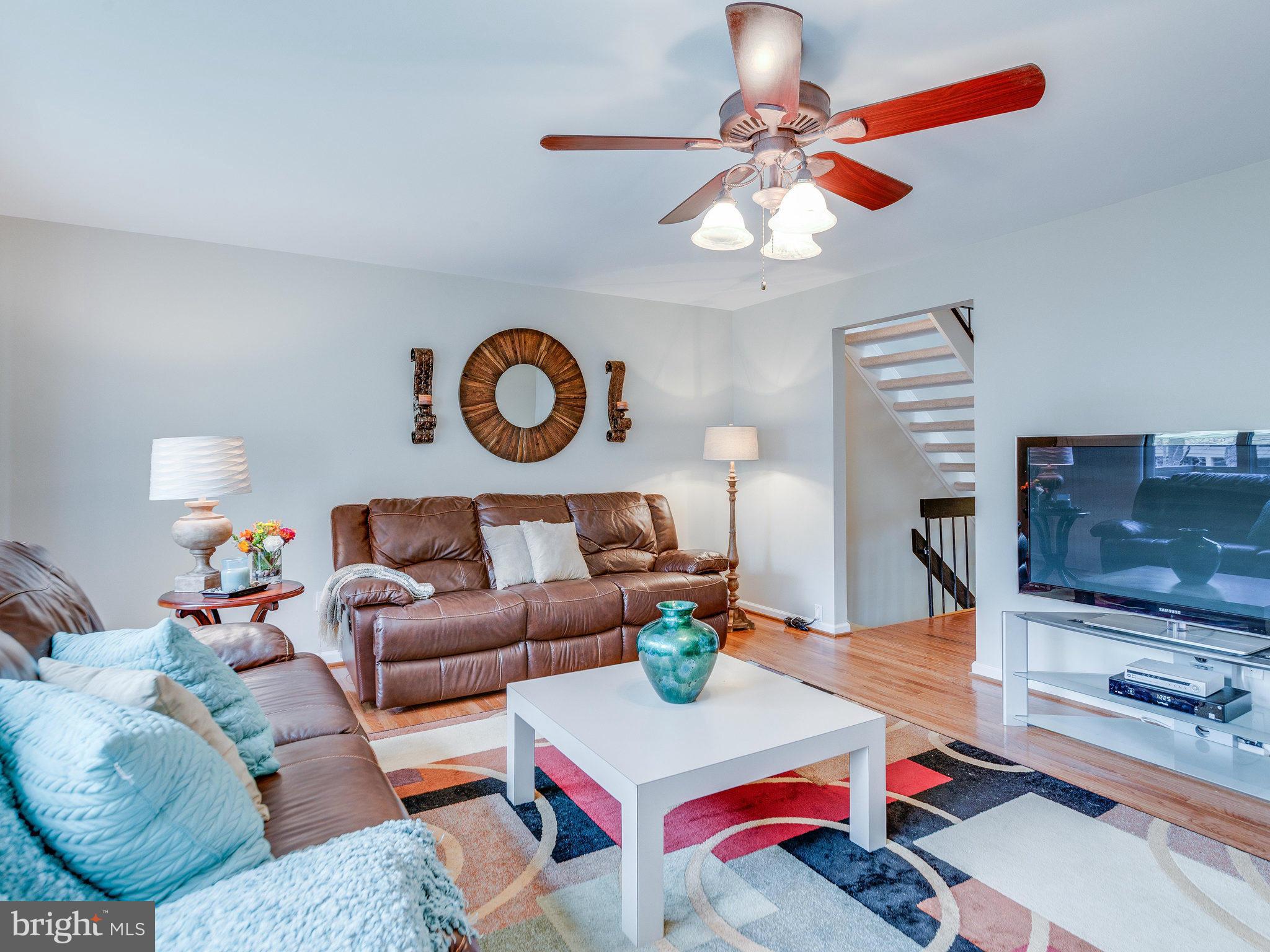 2269 Wheelwright Court Reston, VA 20191 - Photo 10 of 28 a living room with furniture a rug and a chandelier