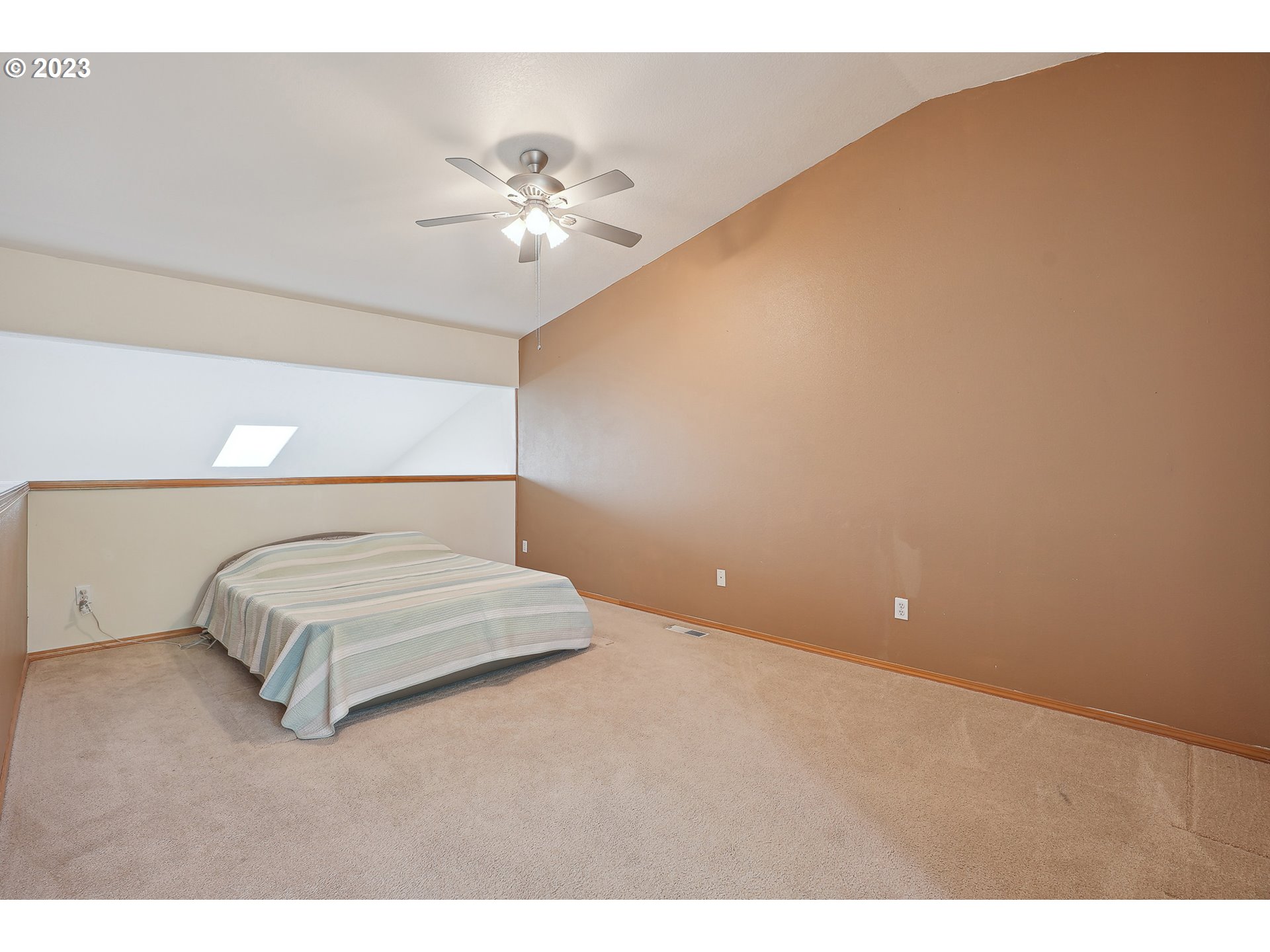 1132 Northeast 6th Street Gresham, OR 97030 - Photo 16 of 29 a spacious bedroom with a bed and a chandelier