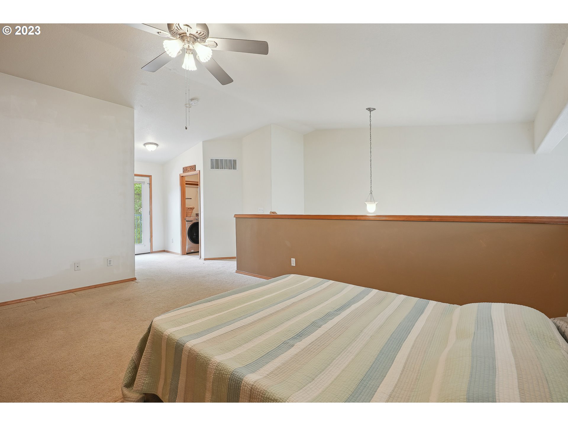1132 Northeast 6th Street Gresham, OR 97030 - Photo 18 of 29 a bedroom with a bed and a chandelier