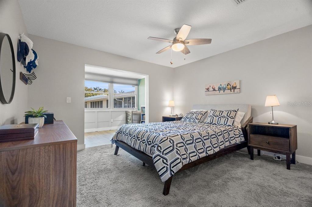 300 Clyde Lane, Unit 215 Dunedin, FL 34698 - Photo 15 of 60 a bedroom with a bed and a chandelier