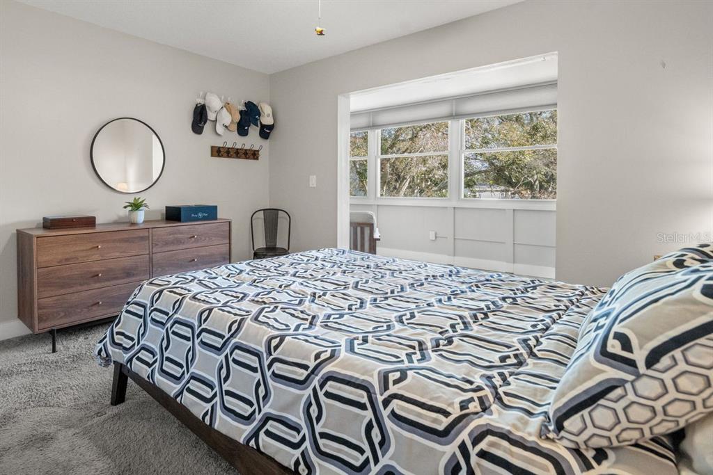 300 Clyde Lane, Unit 215 Dunedin, FL 34698 - Photo 17 of 60 a bedroom with a bed dresser and a window