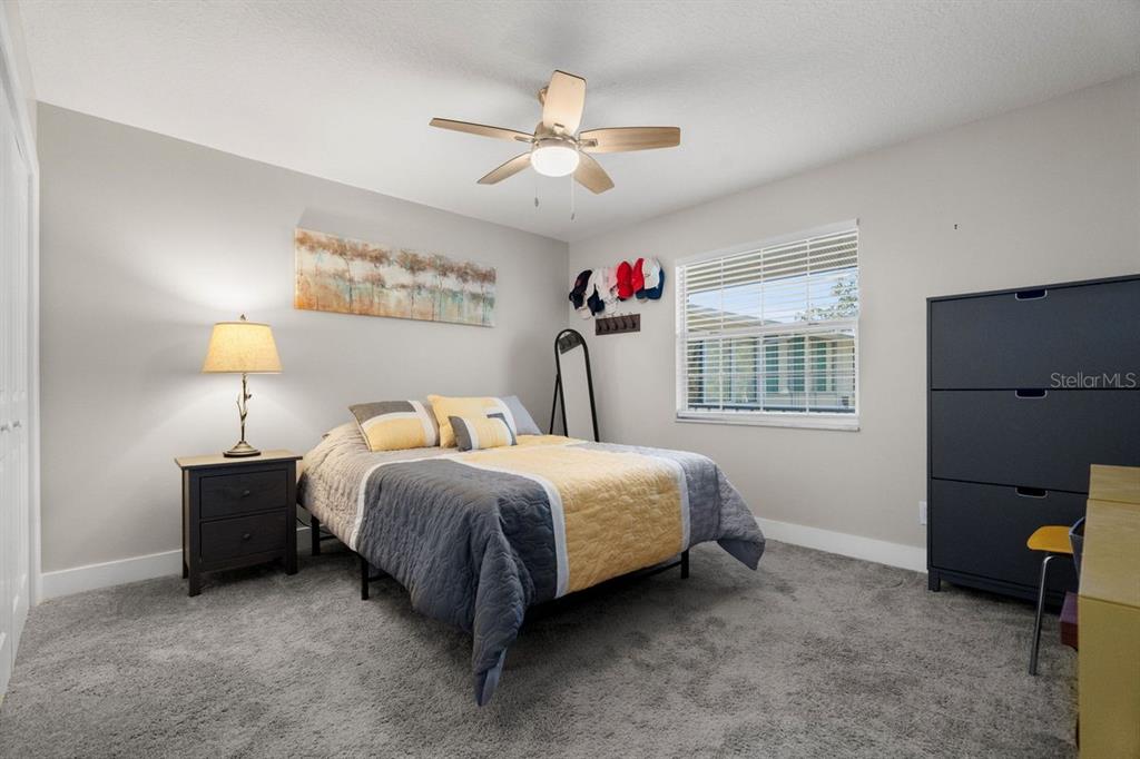 300 Clyde Lane, Unit 215 Dunedin, FL 34698 - Photo 19 of 60 a spacious bedroom with a bed and a window