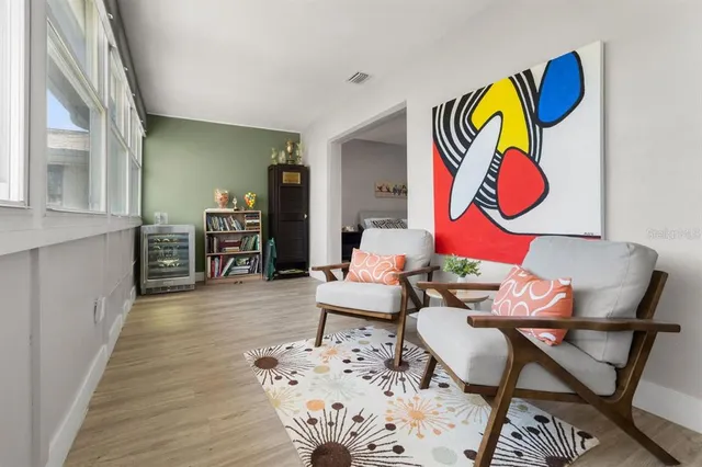 a living room with furniture and kitchen view