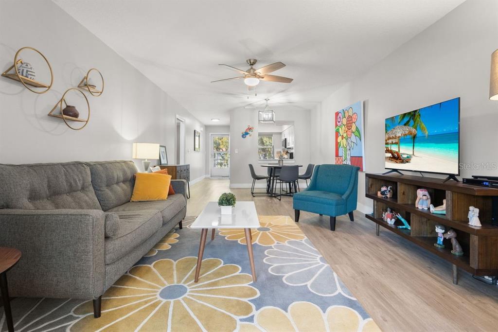 300 Clyde Lane, Unit 215 Dunedin, FL 34698 - Photo 24 of 60 a living room with furniture a couch and a bookshelf