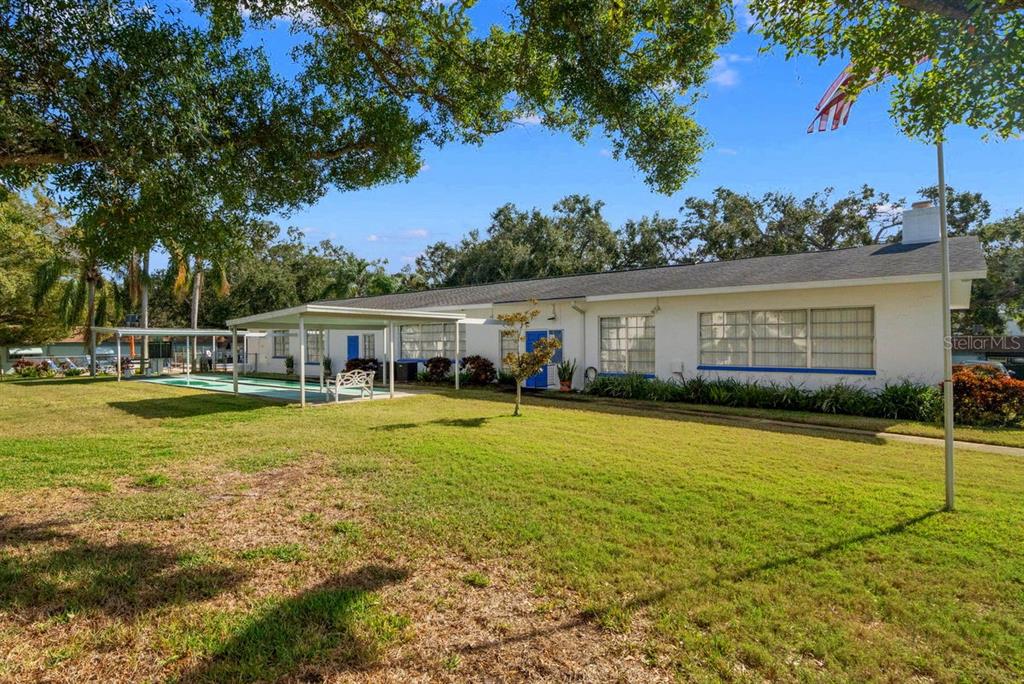300 Clyde Lane, Unit 215 Dunedin, FL 34698 - Photo 35 of 60 a front view of house with yard and seating area
