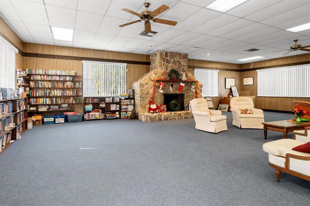 300 Clyde Lane, Unit 215 Dunedin, FL 34698 - Photo 37 of 60 a bed room with furniture and a chandelier