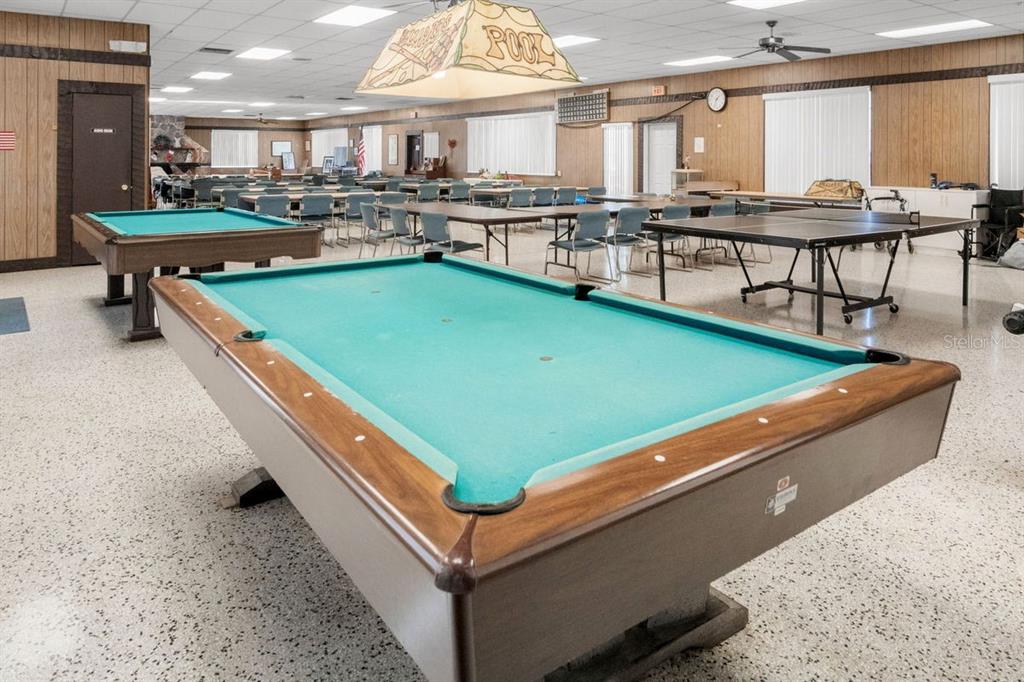 300 Clyde Lane, Unit 215 Dunedin, FL 34698 - Photo 38 of 60 a room with lots of furniture and windows