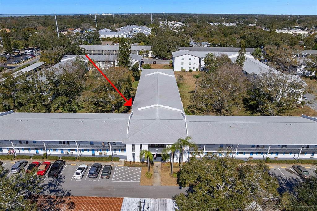 300 Clyde Lane, Unit 215 Dunedin, FL 34698 - Photo 4 of 60 an aerial view of residential houses with outdoor space and ocean view