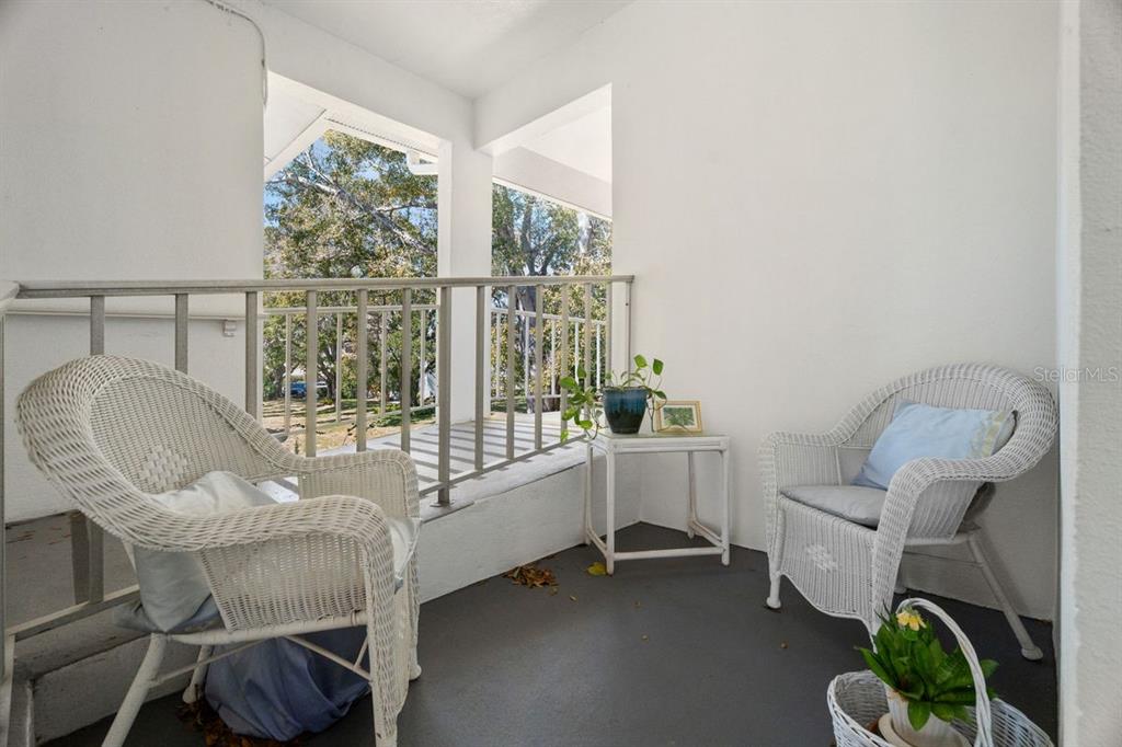 300 Clyde Lane, Unit 215 Dunedin, FL 34698 - Photo 5 of 60 a living room with furniture and a large window