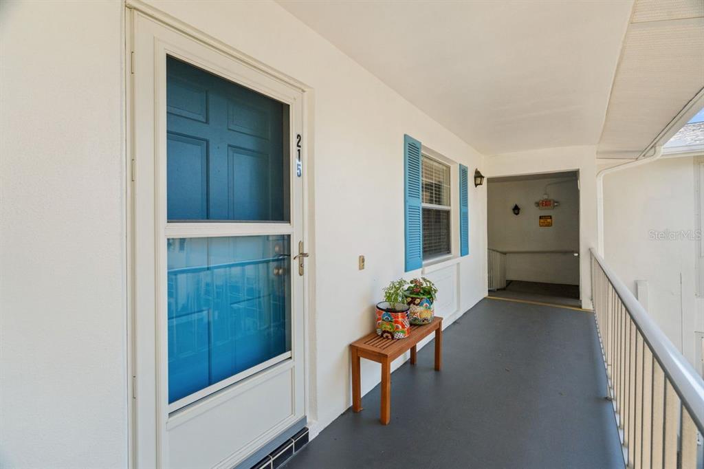 300 Clyde Lane, Unit 215 Dunedin, FL 34698 - Photo 6 of 60 a hallway with wooden floor and furniture