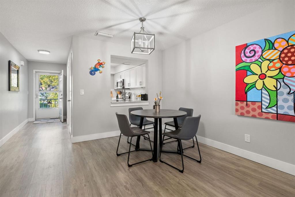 300 Clyde Lane, Unit 215 Dunedin, FL 34698 - Photo 8 of 60 a view of a dining room with furniture and wooden floor