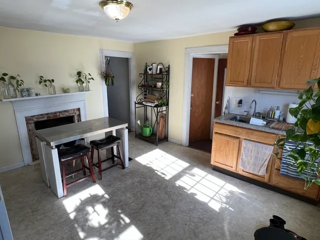 a kitchen with stainless steel appliances kitchen island granite countertop a refrigerator stove and sink