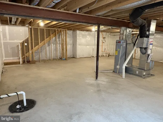 a view of a room that has a window and wooden floor