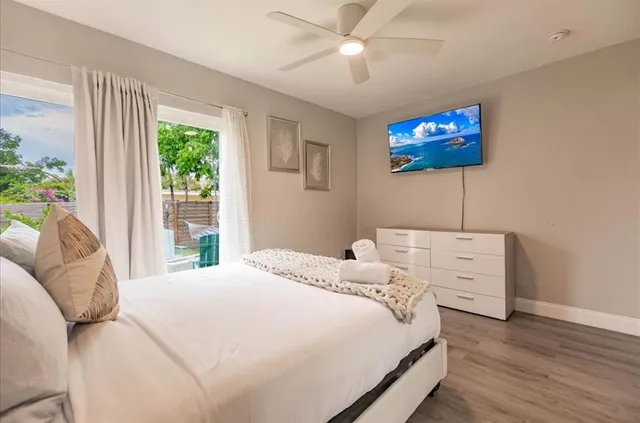 a bedroom with a bed and a flat screen tv