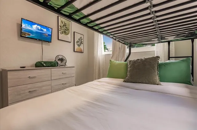 a bedroom with a bed and a chandelier