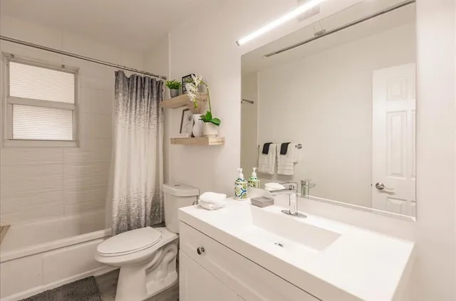 a bathroom with a sink toilet and shower