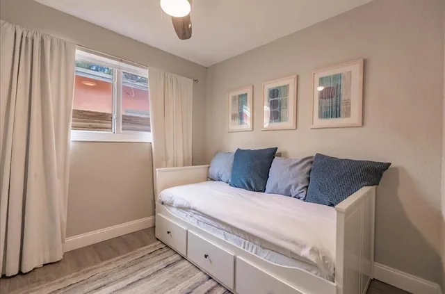 a living room with a bed and a window