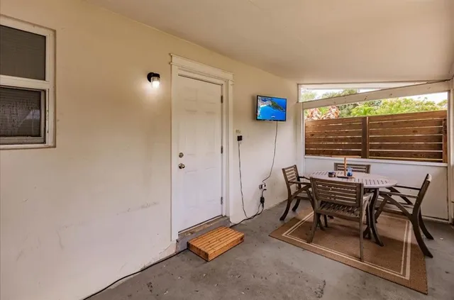 a view of a livingroom with furniture and a window