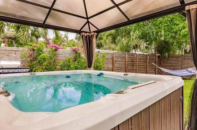 a view of a swimming pool with a porch and furniture