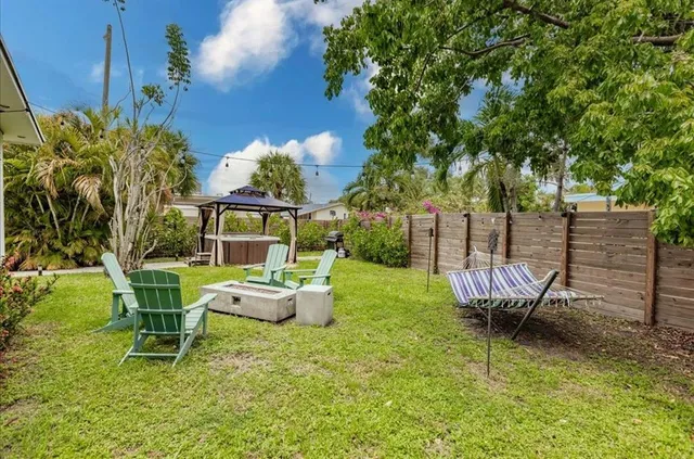 a view of a chairs and table in backyard