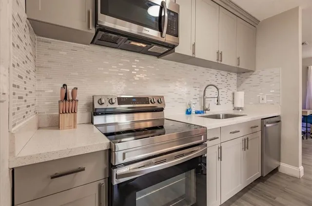a kitchen with a stove and a sink