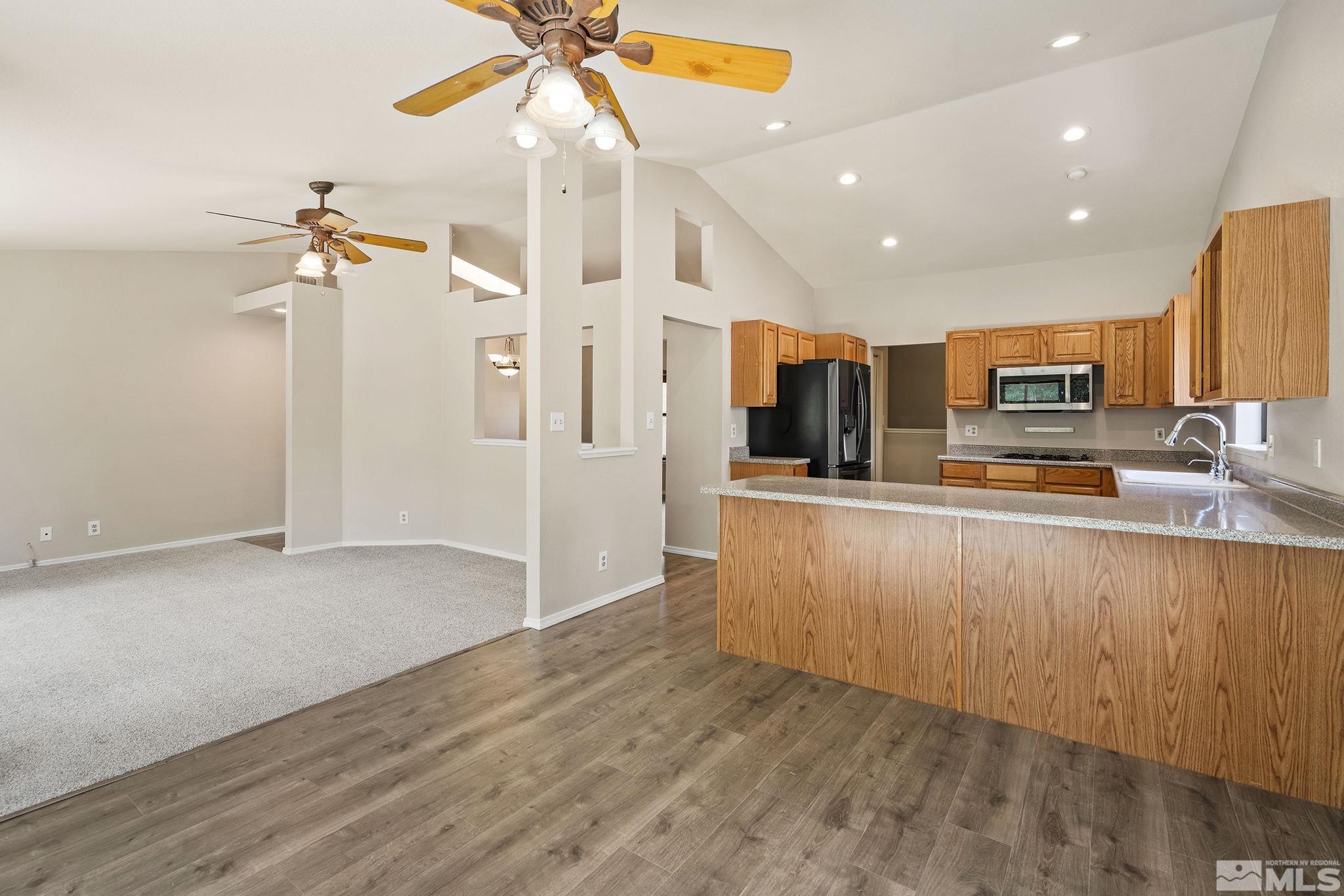 540 Citadel Road Reno, NV 89503 - Photo 9 of 30 a view of a kitchen with stainless steel appliances granite countertop a refrigerator and a sink
