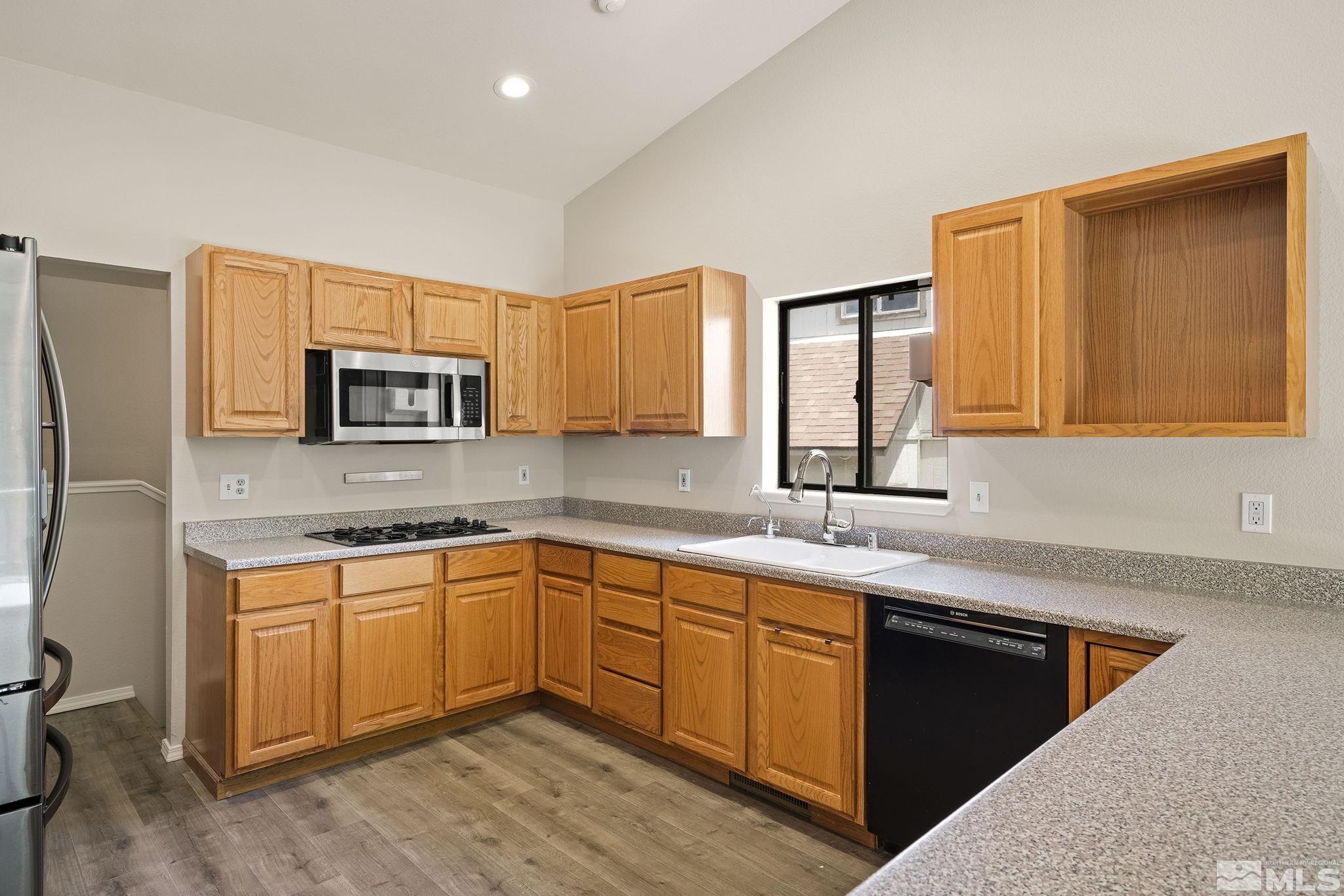 540 Citadel Road Reno, NV 89503 - Photo 10 of 30 a kitchen with stainless steel appliances granite countertop a sink stove and microwave
