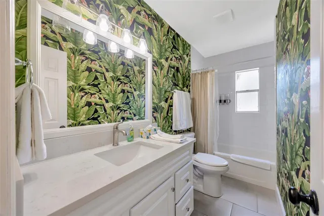 a bathroom with a sink a toilet and shower curtain