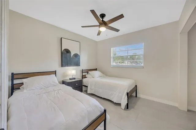 a bedroom with two beds and painting on the wall