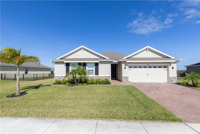 a view of a house with a yard and a porch