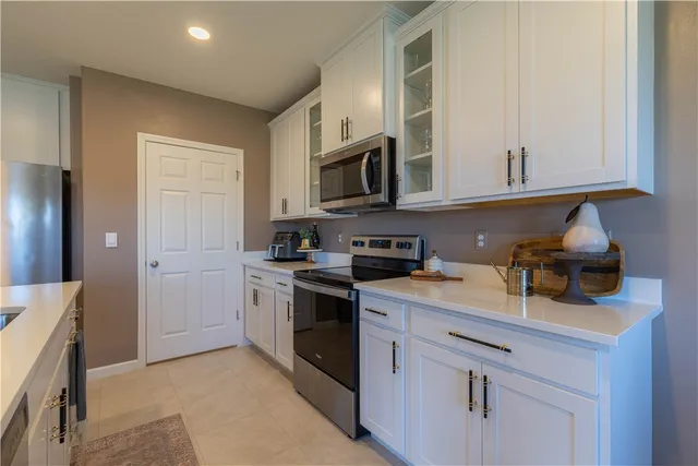 a kitchen with stainless steel appliances granite countertop a sink and a stove