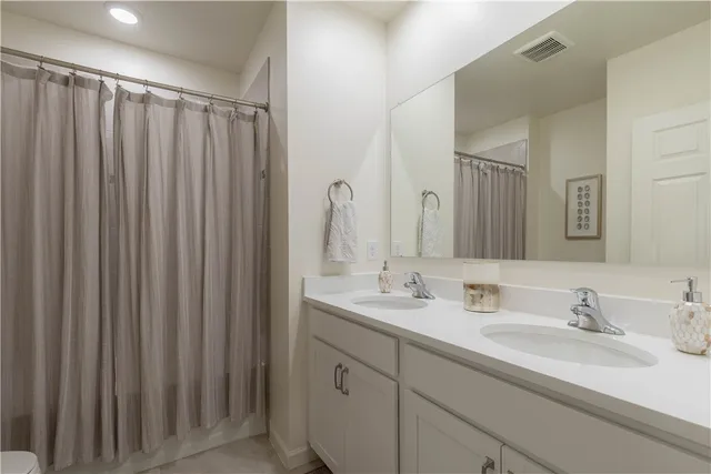 a bathroom with a double vanity sink and mirror