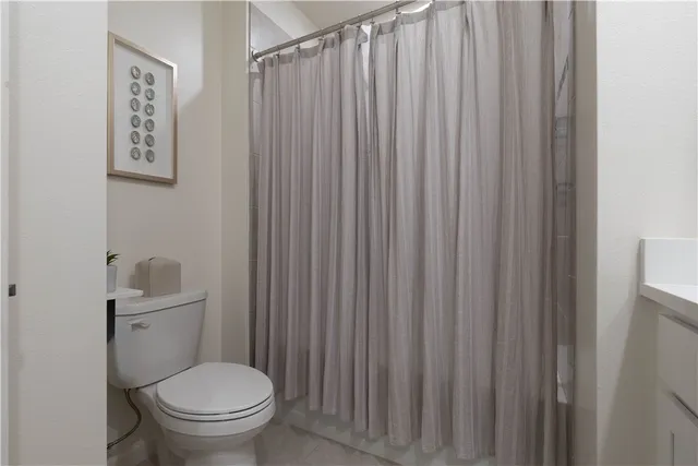 a white toilet sitting next to a small yard