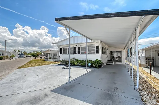 a view of a house with backyard porch and sitting area
