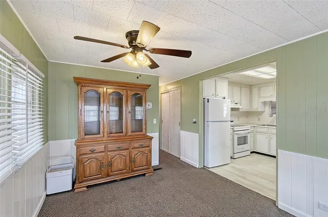 a bedroom with a bed and ceiling fan