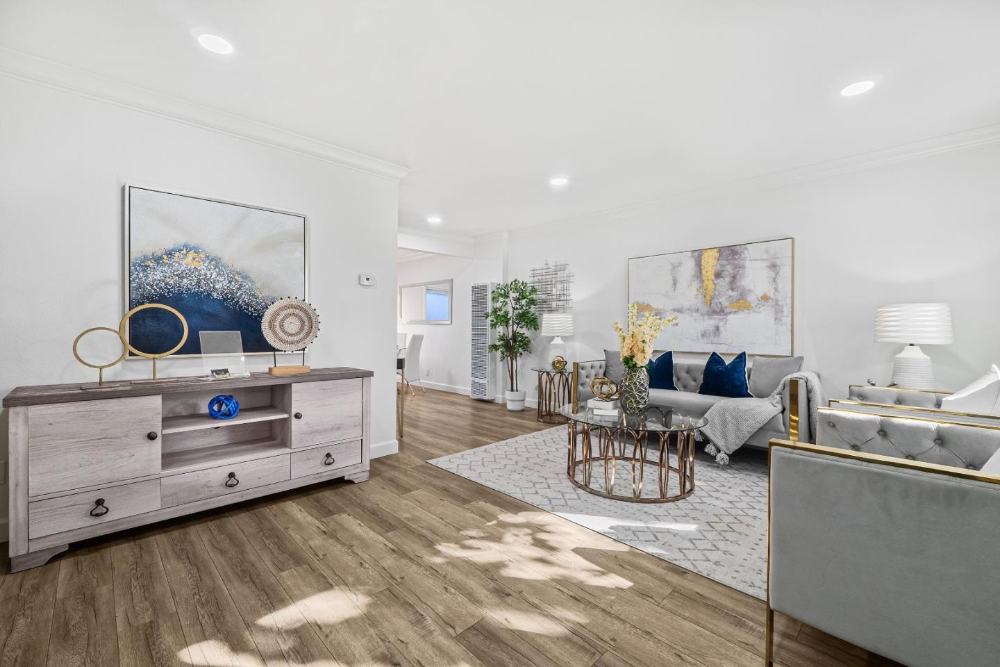 a living room with furniture and wooden floor