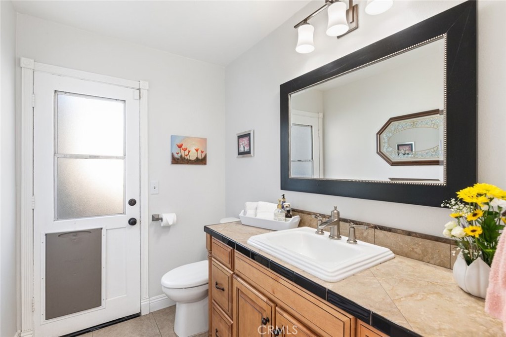 30198 La Primavera Street Temecula, CA 92592 - Photo 16 of 50 a bathroom with a granite countertop sink a toilet and a mirror