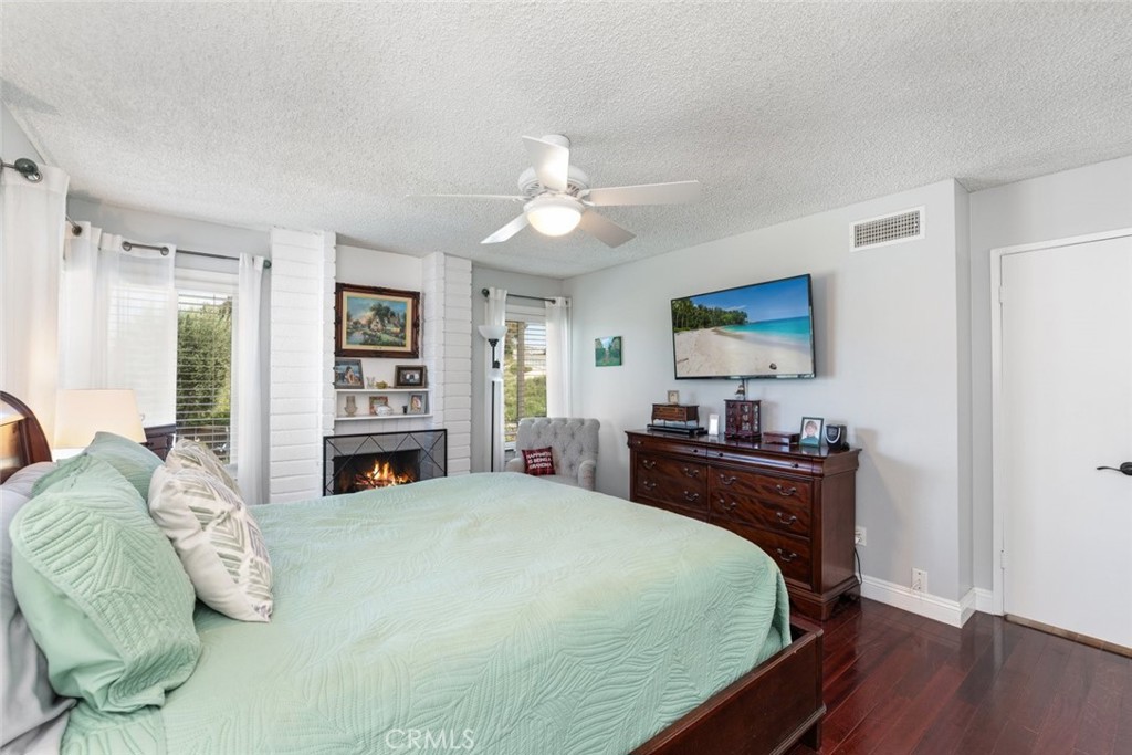 30198 La Primavera Street Temecula, CA 92592 - Photo 24 of 50 a spacious bedroom with a bed and a chandelier