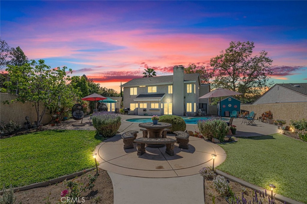 30198 La Primavera Street Temecula, CA 92592 - Photo 28 of 50 a view of a house with backyard sitting area and garden
