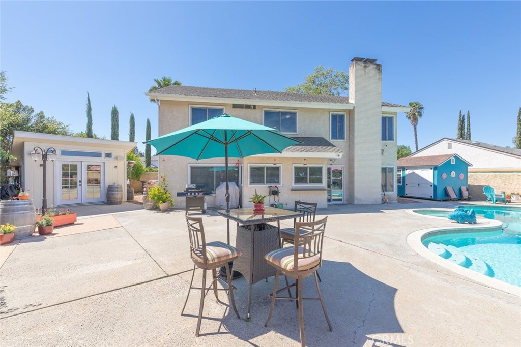 30198 La Primavera Street Temecula, CA 92592 - Photo 33 of 50 a patio with a table and chairs under an umbrella
