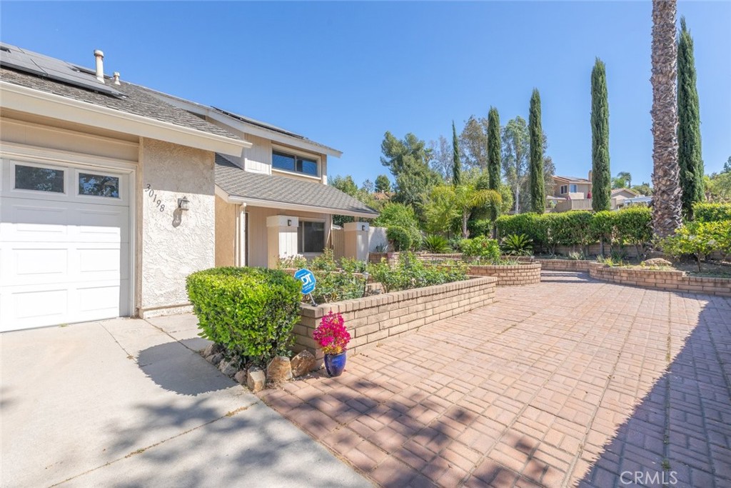 30198 La Primavera Street Temecula, CA 92592 - Photo 4 of 50 a view of a house with a yard and potted plants