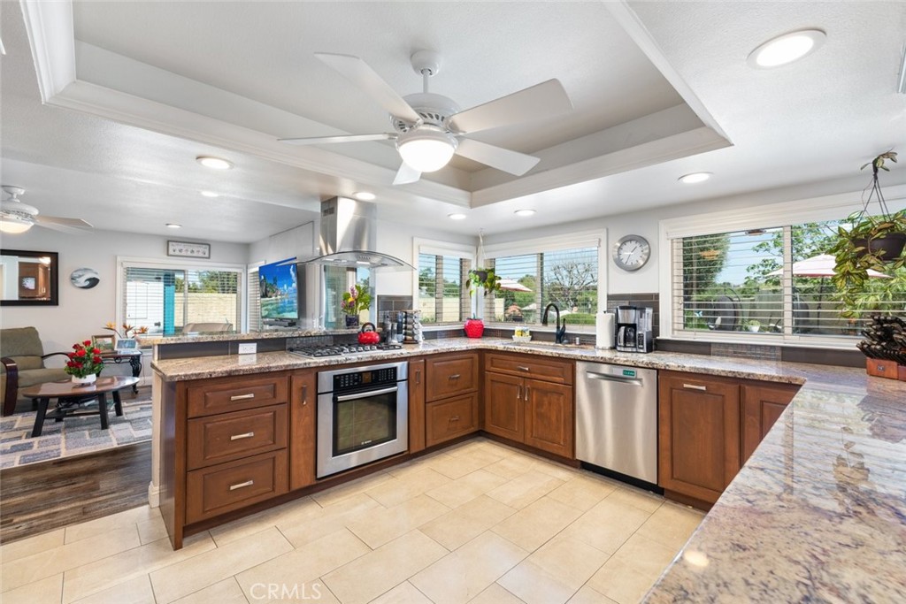30198 La Primavera Street Temecula, CA 92592 - Photo 10 of 50 a large kitchen with stainless steel appliances granite countertop lots of counter space and breakfast area