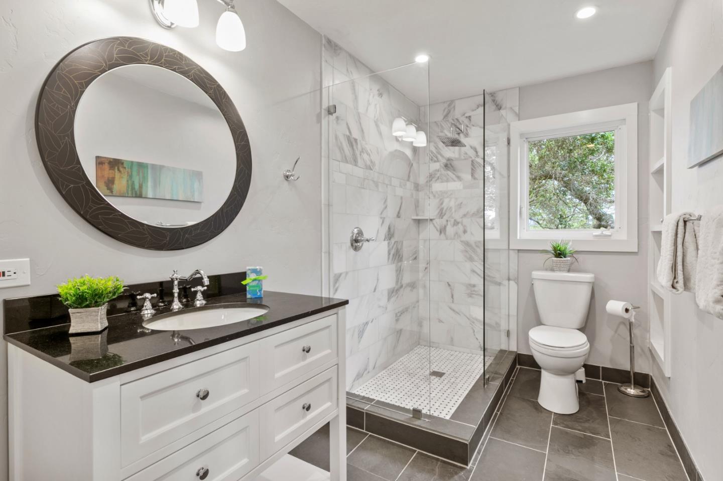 30 Knollcrest Road Hillsborough, CA 94010 - Photo 24 of 33 a bathroom with a granite countertop sink a toilet a mirror and shower