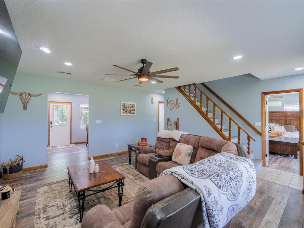4381 Northeast 105th Place Anthony, FL 32617 - Photo 19 of 49 a living room with furniture and a ceiling fan