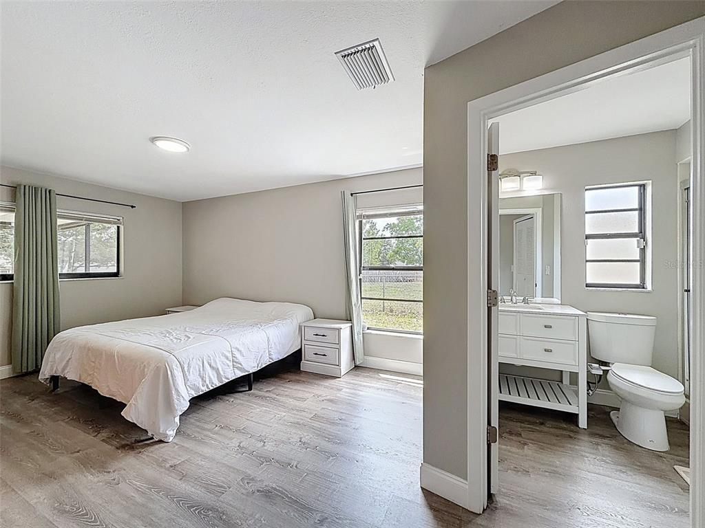 5384 Baldock Avenue Spring Hill, FL 34608 - Photo 27 of 51 a bedroom with a bed and a view of bathroom