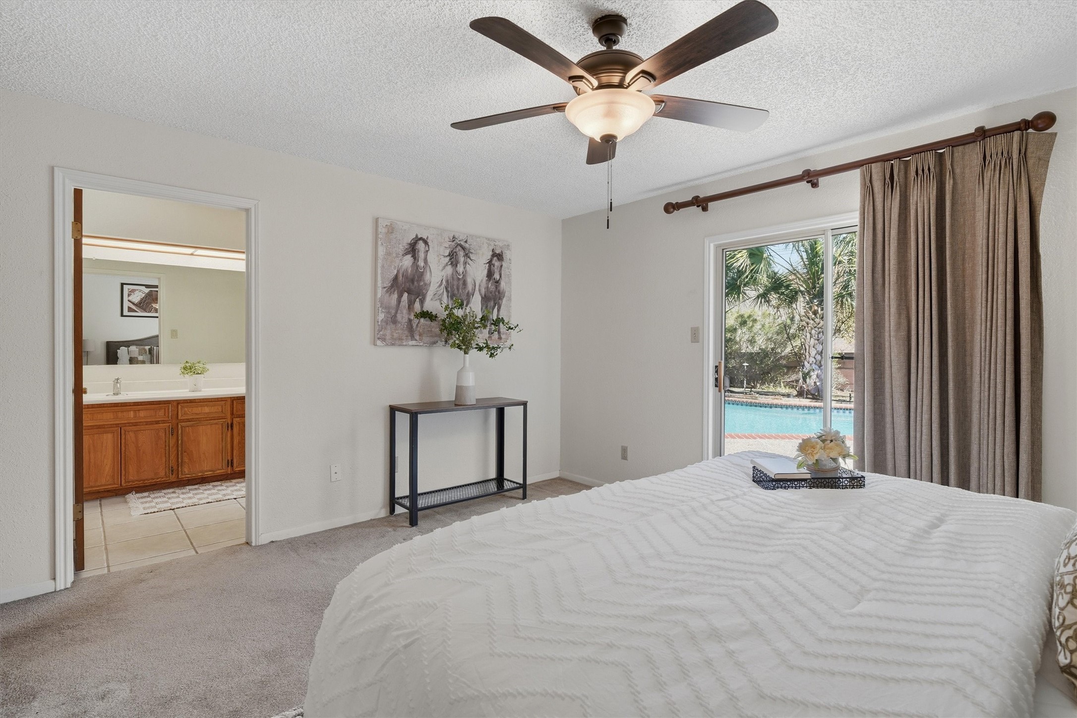 15015 Pleasant Valley Road Houston, TX 77062 - Photo 14 of 21 a bedroom with a large bed and a chandelier fan